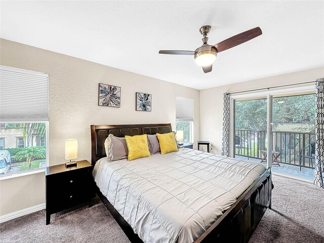 carpeted bedroom featuring multiple windows, ceiling fan, and access to outside