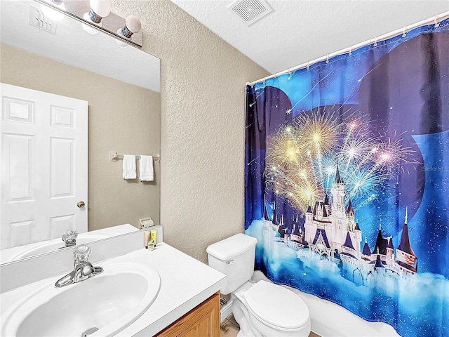 full bathroom with vanity, shower / bath combination with curtain, a textured ceiling, and toilet