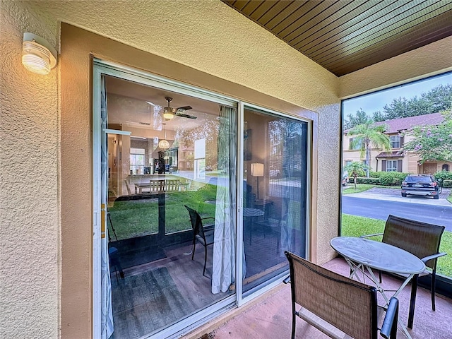 exterior space with wood-type flooring and ceiling fan