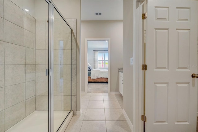 bathroom with tile patterned floors and a shower with shower door