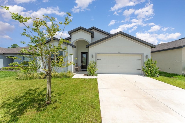 view of front of home with a garage and a front yard