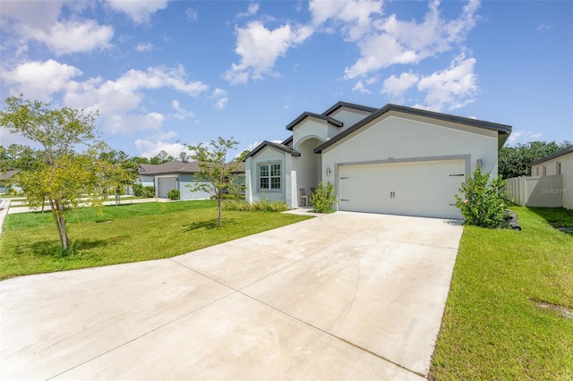 view of front of home featuring a garage and a front yard