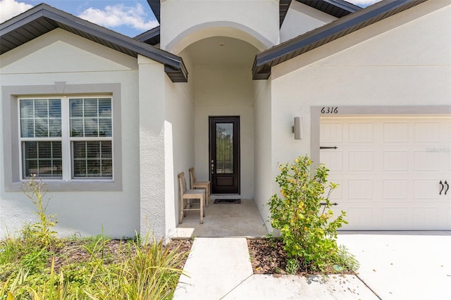 view of exterior entry featuring a garage