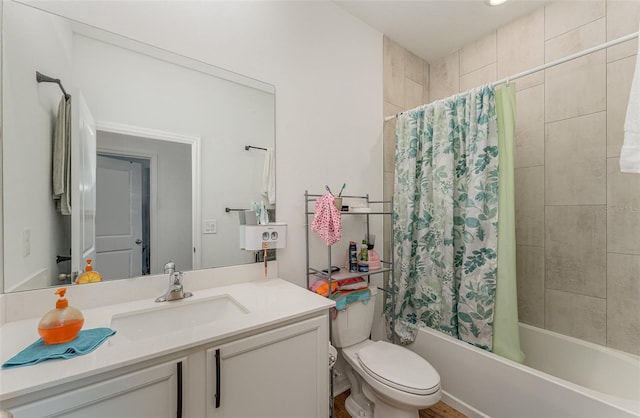 full bathroom featuring shower / bath combo with shower curtain, vanity, and toilet