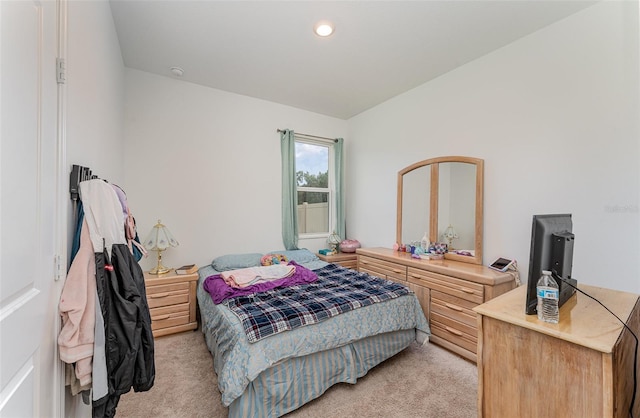 bedroom featuring light carpet