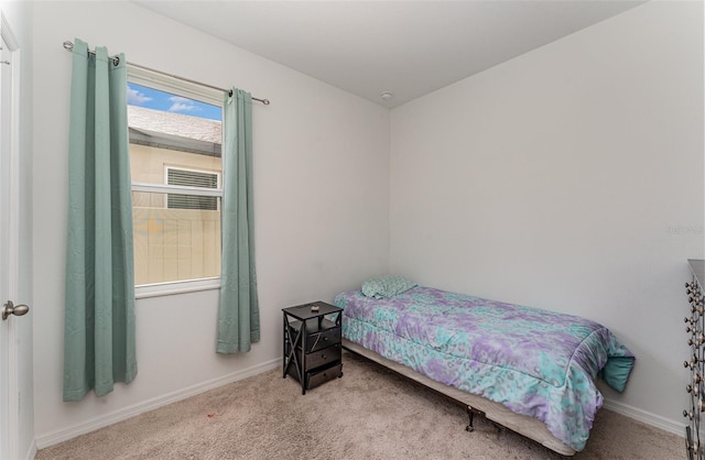 bedroom featuring light colored carpet