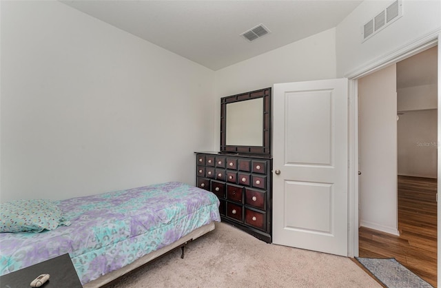 bedroom with hardwood / wood-style flooring