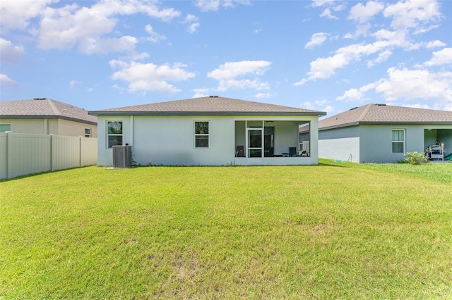 back of house with a yard and central AC unit