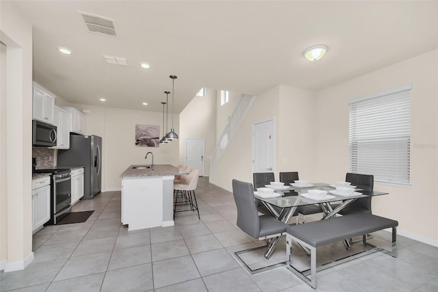 tiled dining room featuring sink