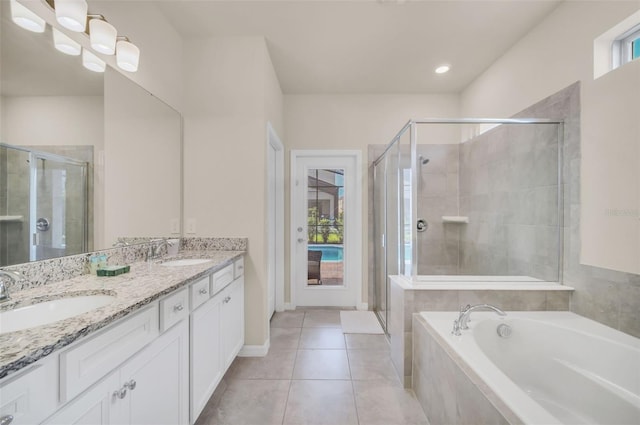 bathroom featuring double vanity, tile patterned flooring, and independent shower and bath