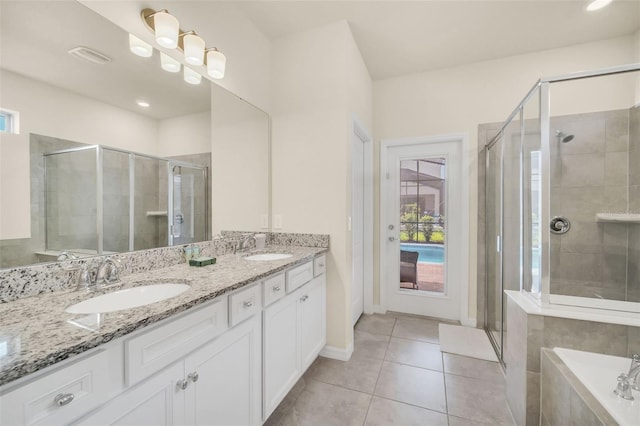 bathroom with plus walk in shower, tile patterned floors, and double sink vanity