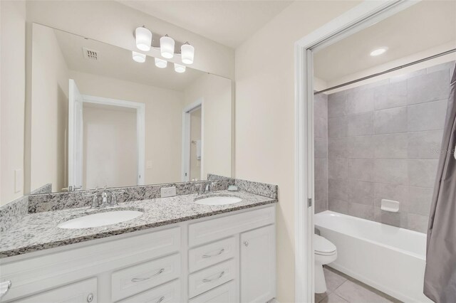 full bathroom with dual vanity, shower / bath combo with shower curtain, tile patterned flooring, and toilet