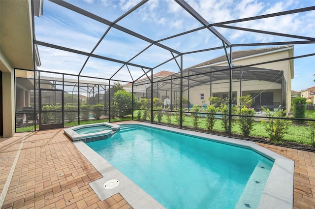 view of pool featuring a patio, an in ground hot tub, and glass enclosure