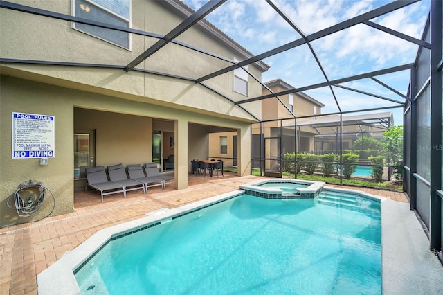 view of pool featuring an in ground hot tub, a patio area, and a lanai