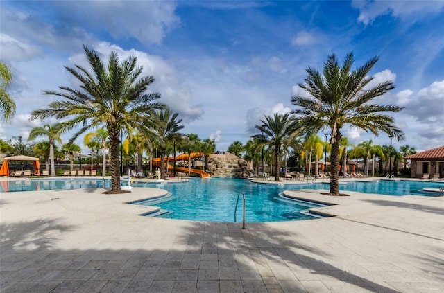 view of pool with a patio and a water slide