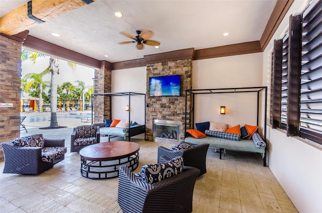 view of patio / terrace with an outdoor living space with a fireplace and ceiling fan