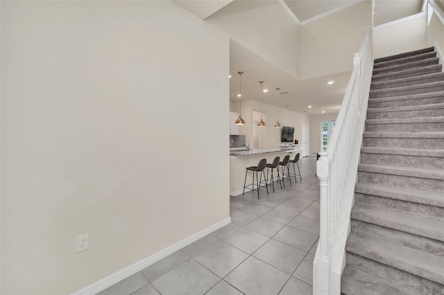 stairway featuring light tile patterned floors