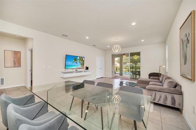 tiled dining area featuring an inviting chandelier