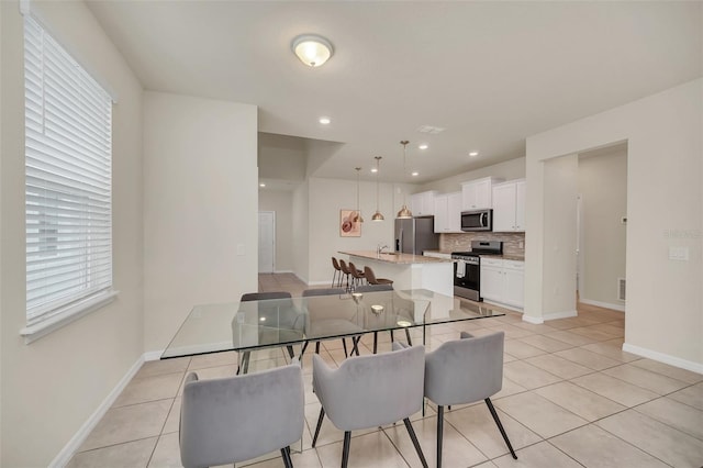 dining space featuring light tile patterned floors and a wealth of natural light