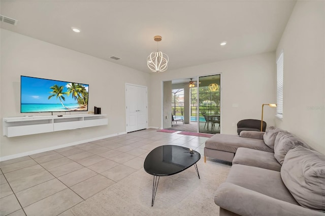 living room featuring a notable chandelier and light tile patterned flooring