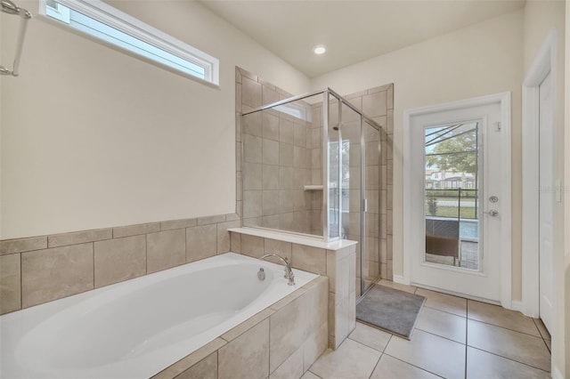 bathroom featuring tile patterned flooring and shower with separate bathtub