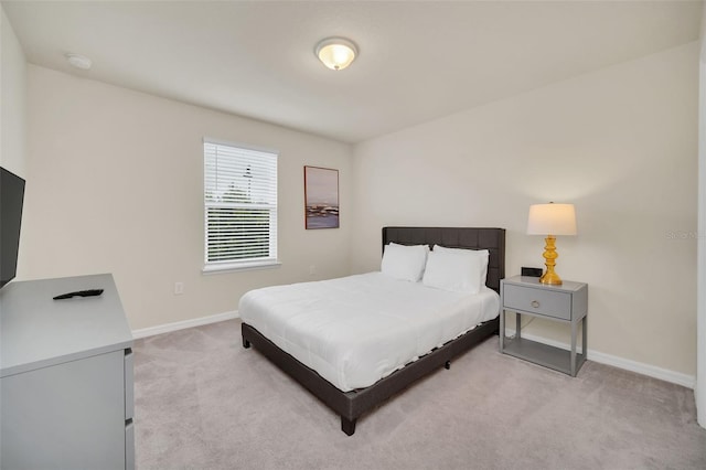 bedroom featuring light carpet