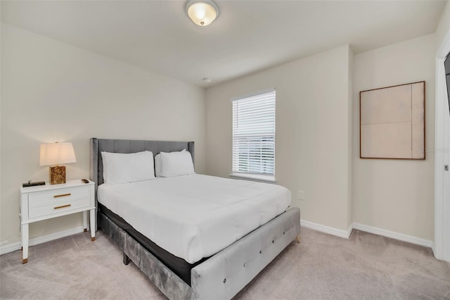 bedroom featuring light colored carpet