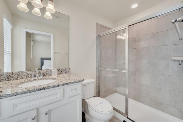 bathroom with vanity, an inviting chandelier, and toilet