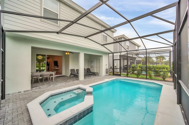 view of pool featuring an in ground hot tub, a patio area, and a lanai