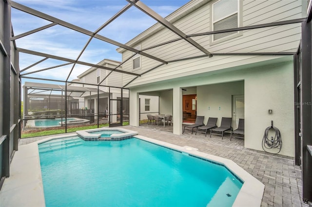 view of pool with an in ground hot tub, a patio, and a lanai