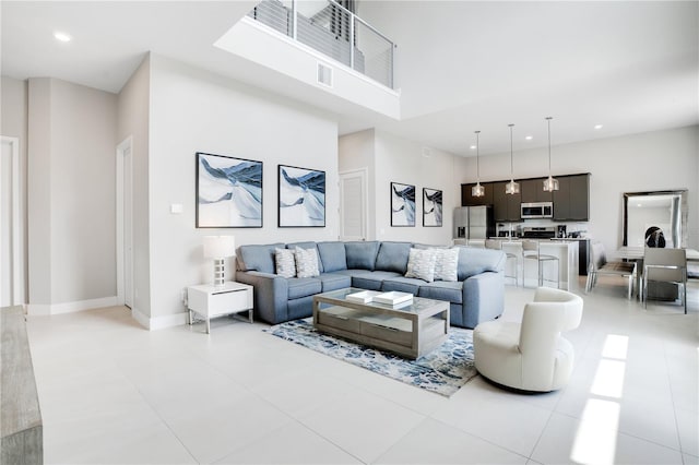 tiled living room featuring a high ceiling