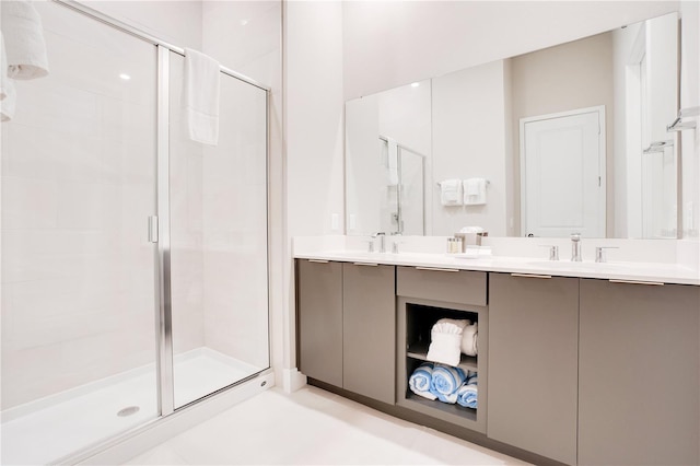 bathroom featuring dual vanity, walk in shower, and tile patterned flooring