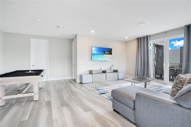 living room featuring light hardwood / wood-style floors and billiards