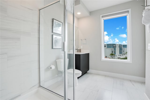 bathroom with vanity, a shower with door, tile patterned flooring, and toilet