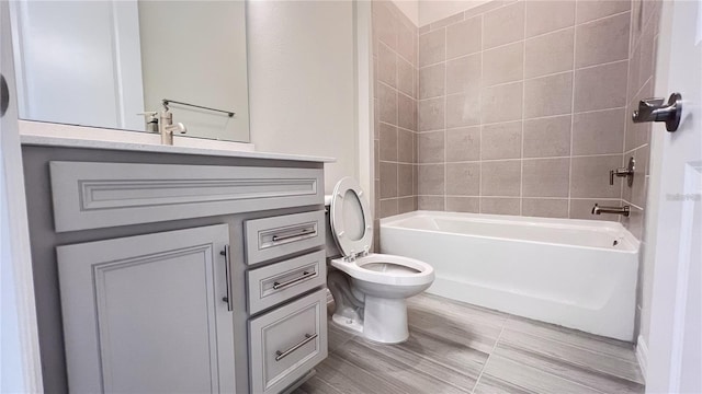 full bathroom with toilet, vanity, and tiled shower / bath combo