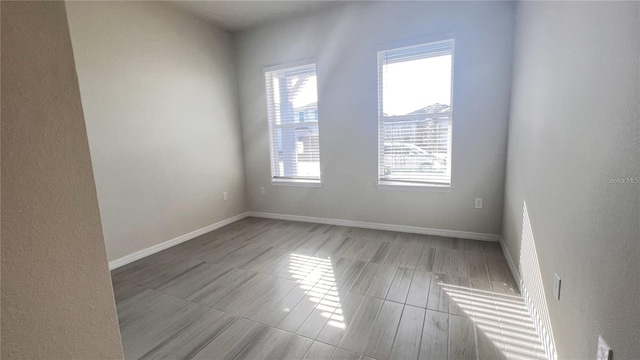 unfurnished room with baseboards