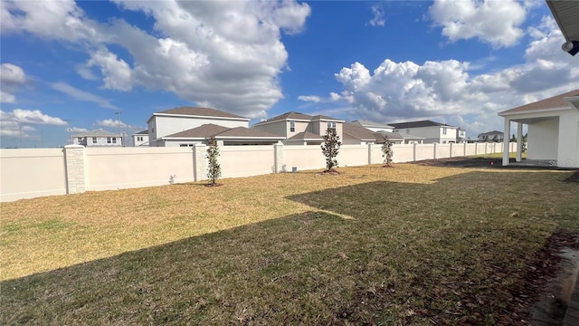 view of yard with a residential view and a fenced backyard