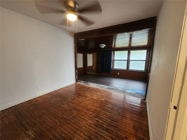 unfurnished room with ceiling fan and dark hardwood / wood-style flooring