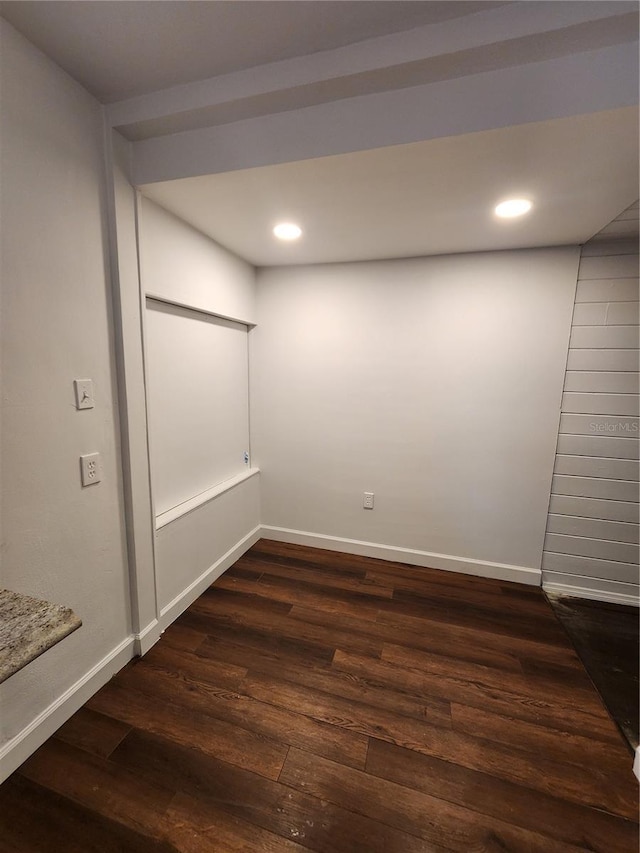 spare room with dark wood-type flooring