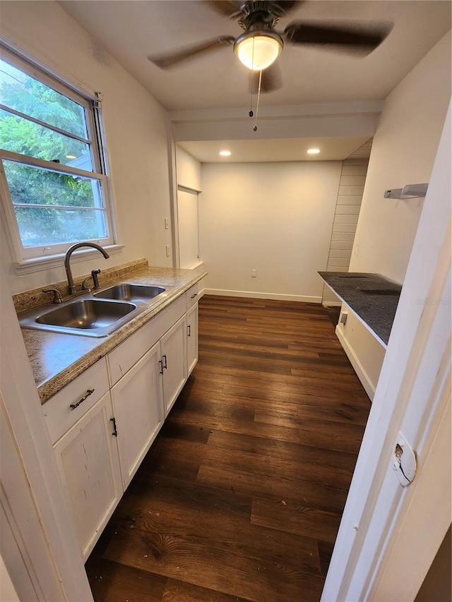 kitchen featuring sink, dark hardwood / wood-style flooring, white cabinetry, and ceiling fan