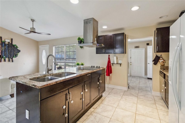 kitchen with light tile patterned floors, ceiling fan, sink, island range hood, and a center island with sink