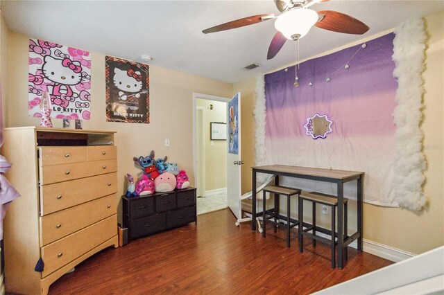 bedroom with ceiling fan and dark hardwood / wood-style flooring