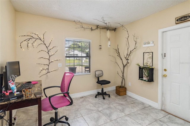 home office featuring a textured ceiling