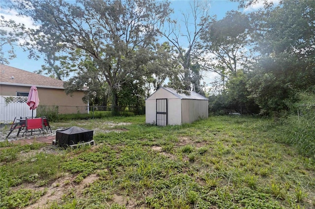 view of yard featuring a patio area and a storage unit