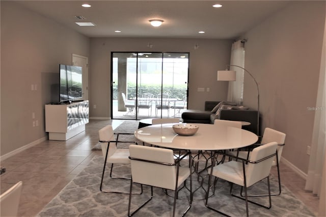 dining space with light tile patterned floors, baseboards, and recessed lighting