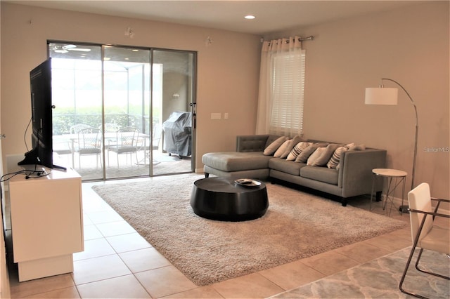 living room with ceiling fan and light tile patterned floors