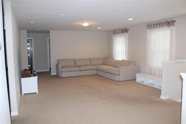 unfurnished living room featuring light carpet