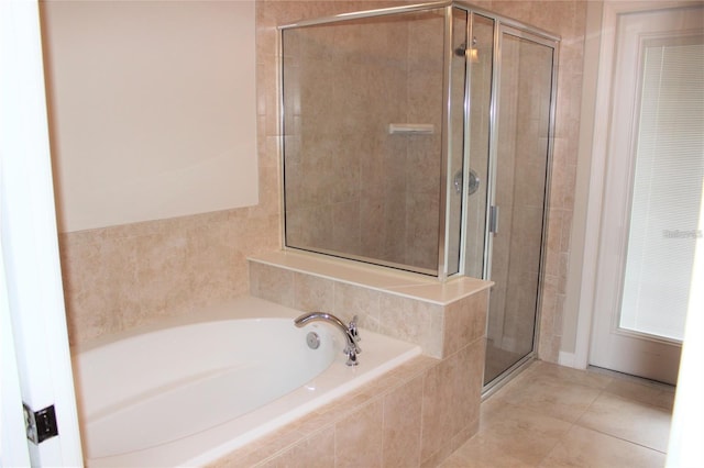 bathroom with independent shower and bath and tile patterned floors