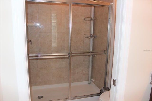 bathroom with walk in shower and toilet