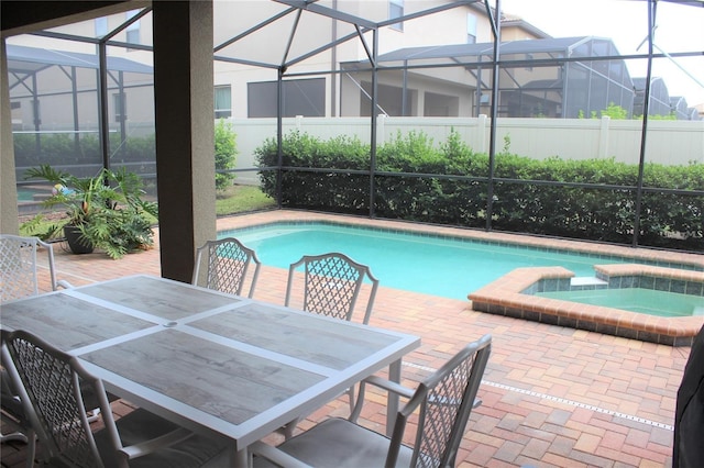 view of swimming pool with an in ground hot tub, a lanai, and a patio